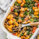 Spicy Southwest Butternut Squash Casserole with wooden spoon.