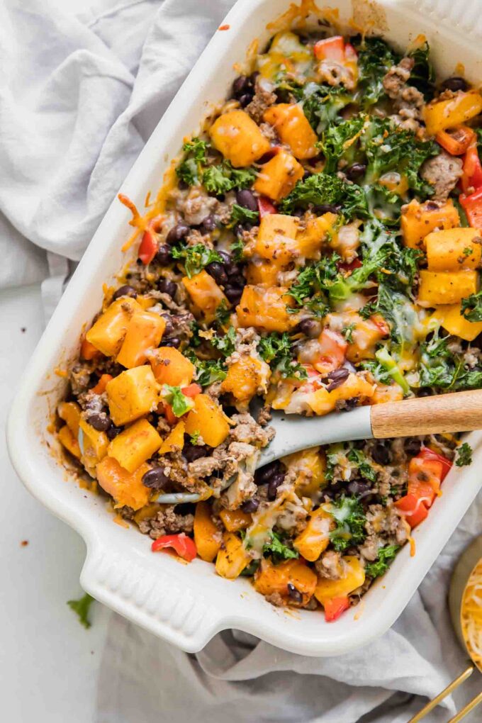 Spicy Southwest Butternut Squash Casserole with wooden spoon.