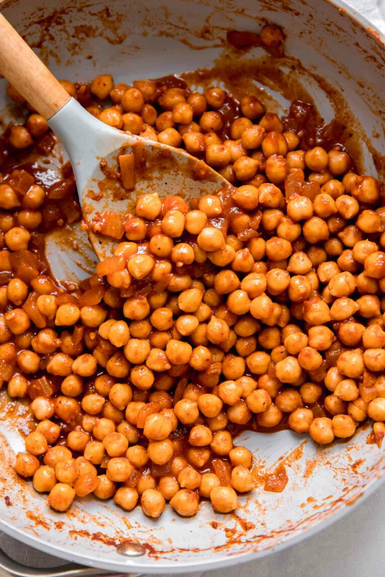 Vegan buffalo chickpeas in a non-stick pan.