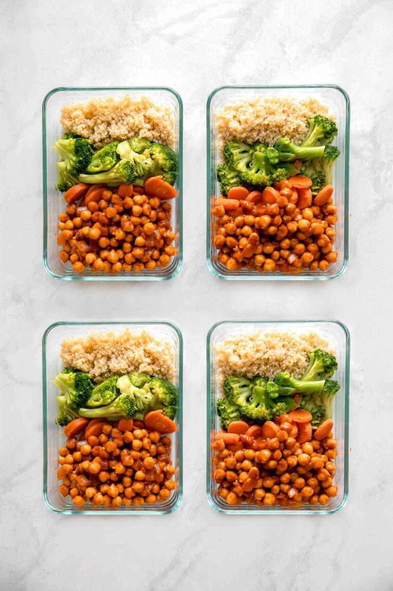4 Vegan meal prep bowls on a marble background.