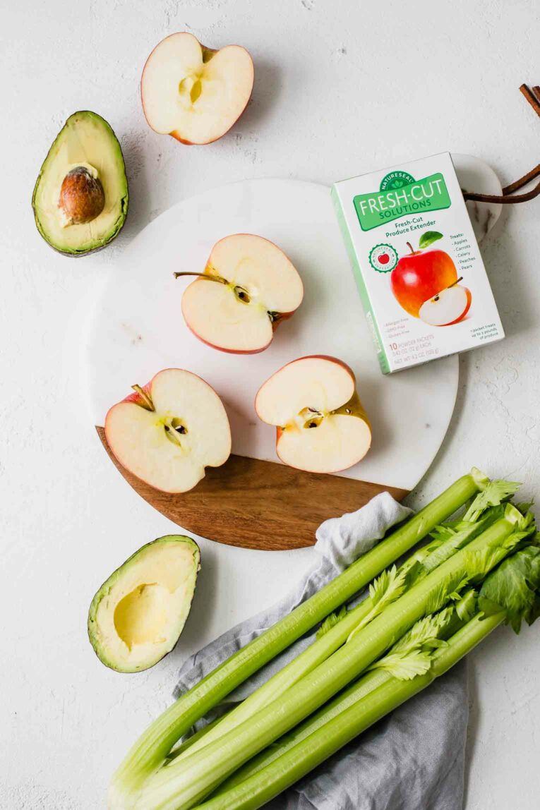 Fresh-cut apples and avocado next to NatureSeal box.