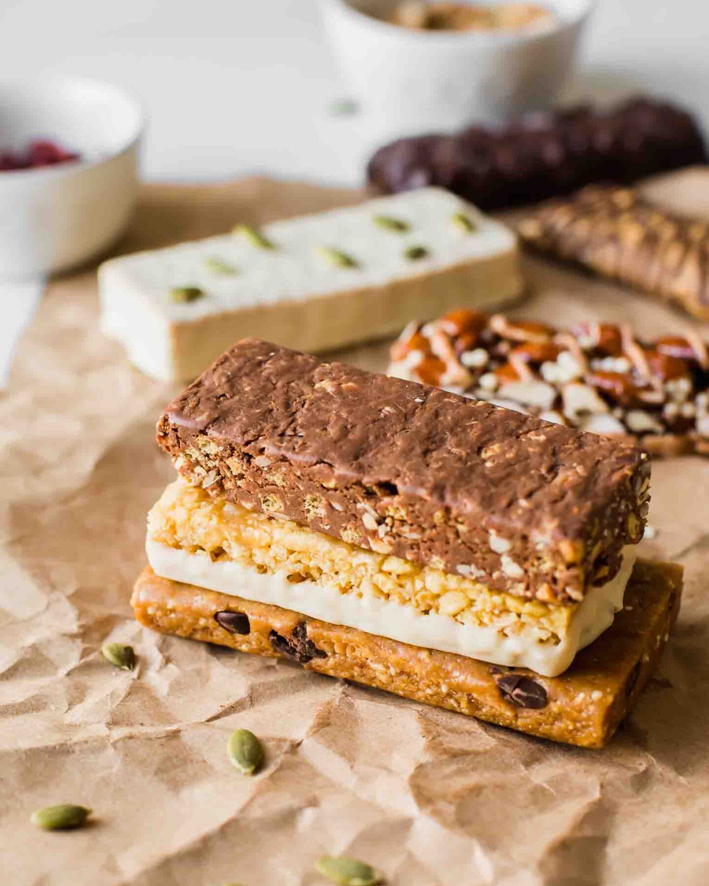 Angled shot of vegan protein bars stacked on a piece of butcher paper.