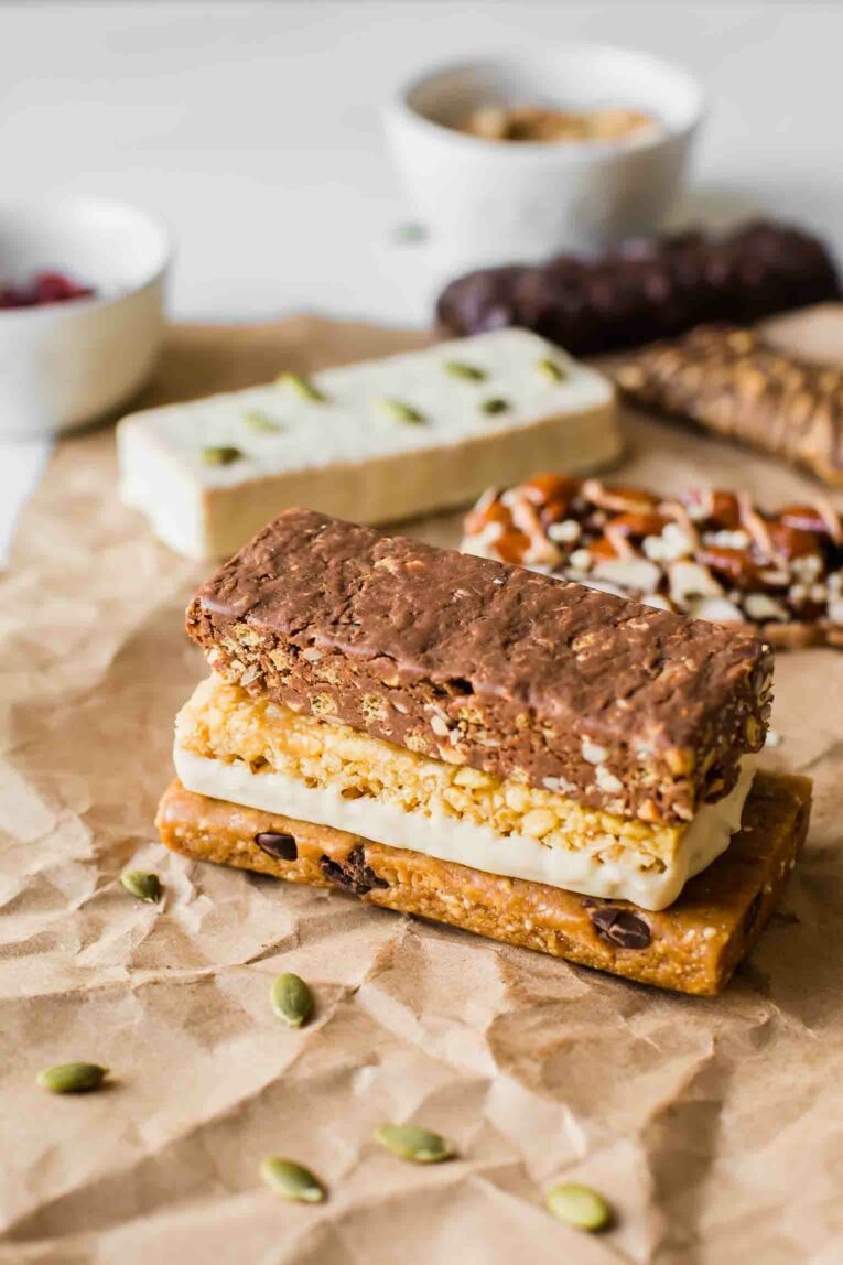 Angled shot of vegan protein bars stacked on a piece of butcher paper.
