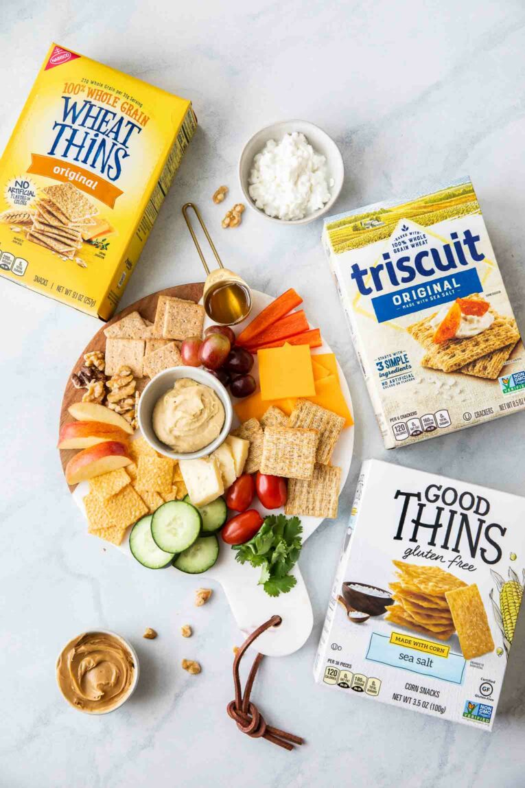 Top shot of cheeseboard next to Good Things, Triscuit, and Wheat Thins boxes.