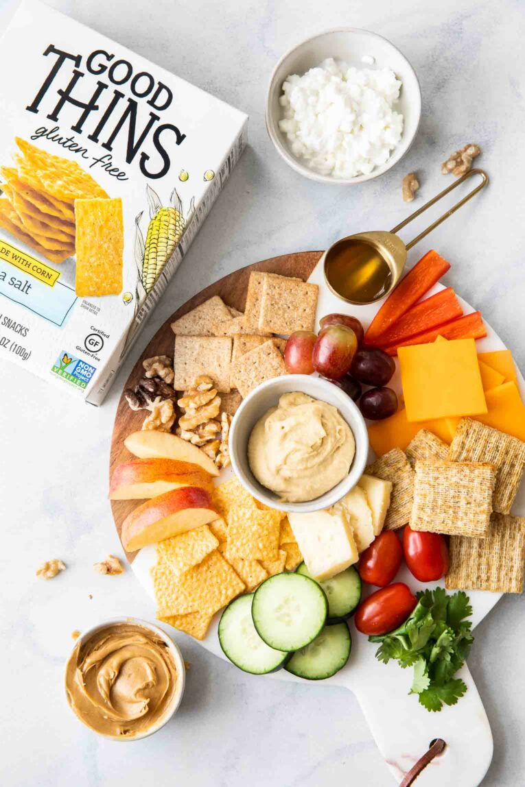 Top shot of round cheeseboard next to Good Thins box.