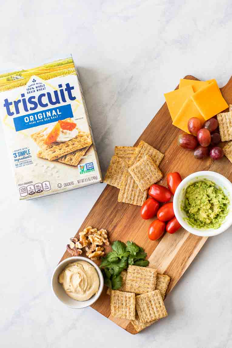 Cheese board next to Triscuit Crackers box.
