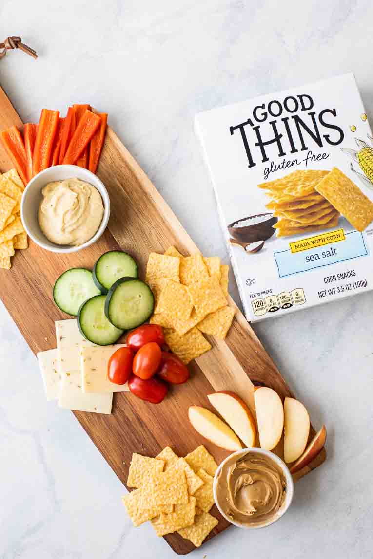 Cheese board next to Good Thins box.