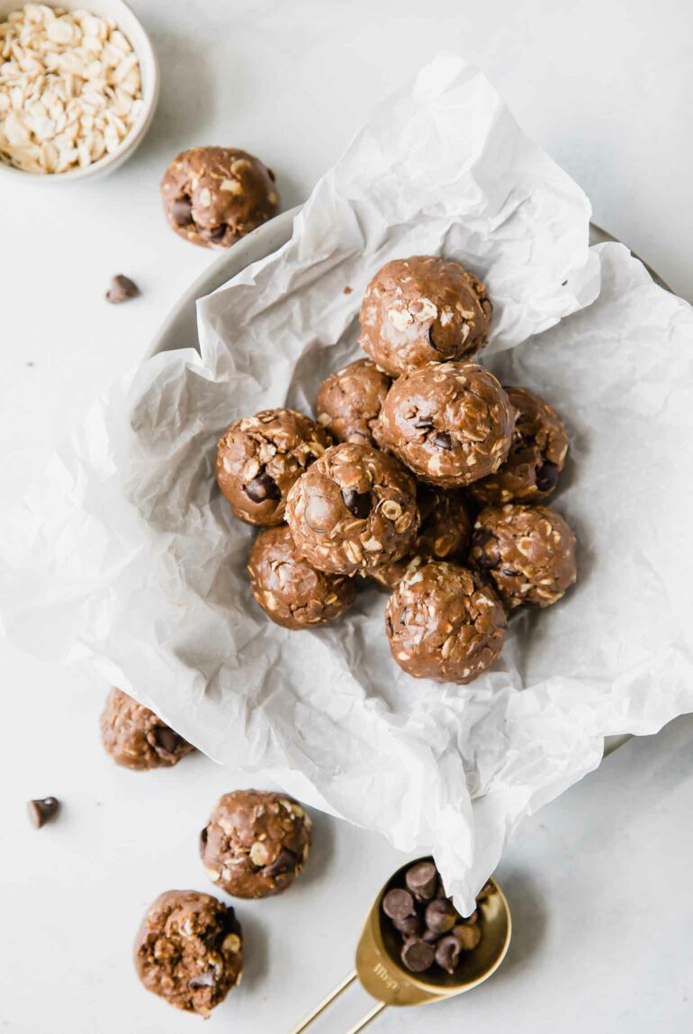 Top shot of chocolate protein balls with peanut butter in a bowl on a counter.