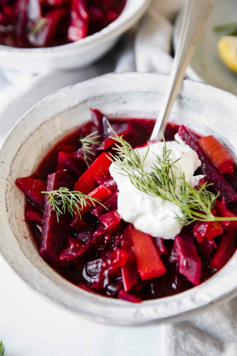 Red Borscht soup in a bowl with a spoon.