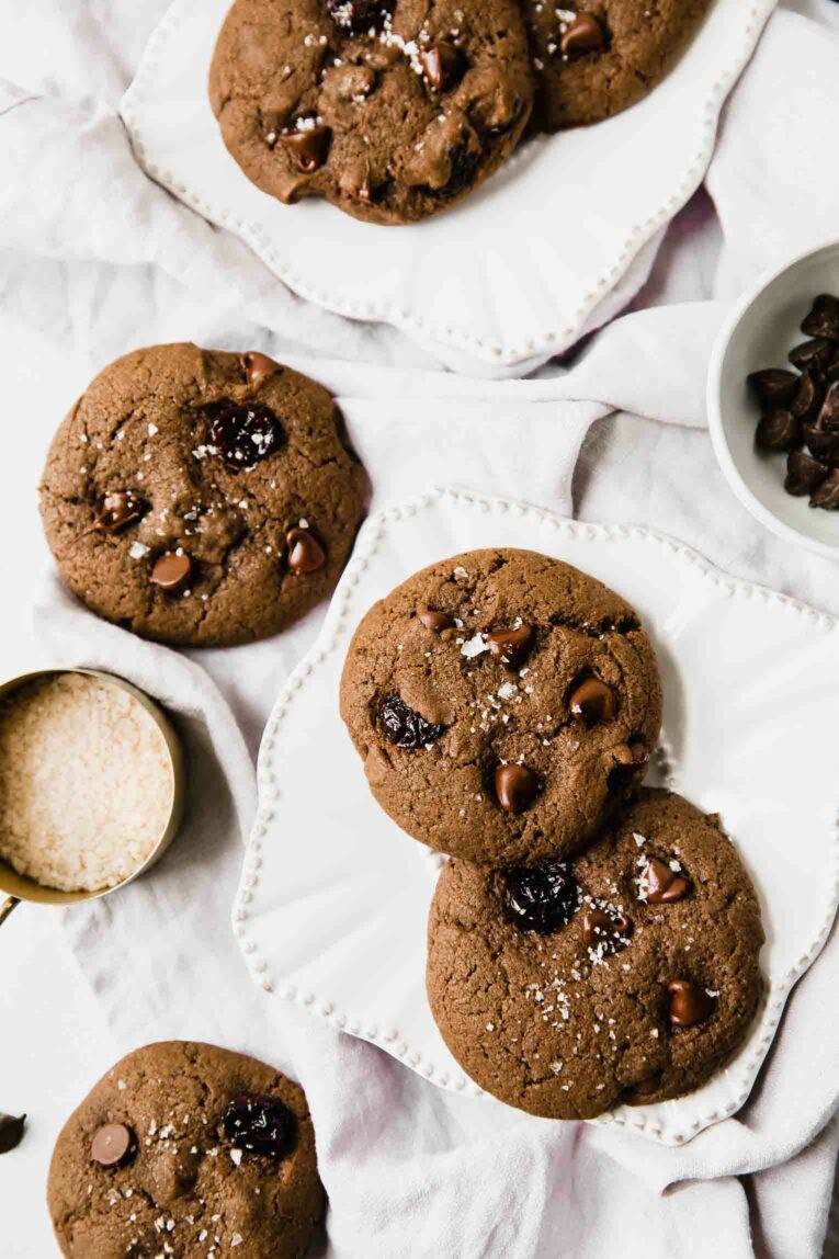 Chocolate cookies with dried cherries and salt on a plate.
