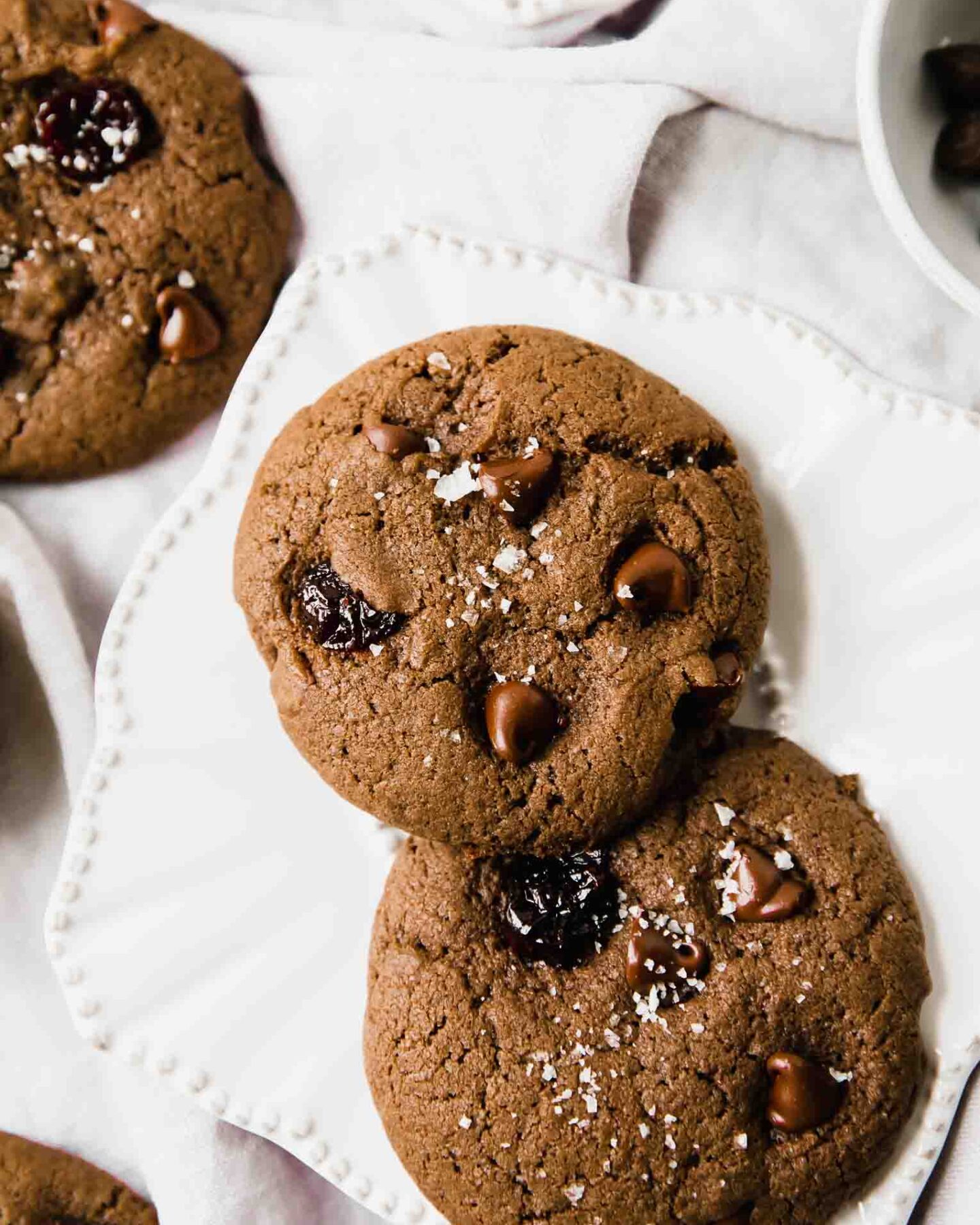 Close up of chocolate cherry soft cookies on a white plate.