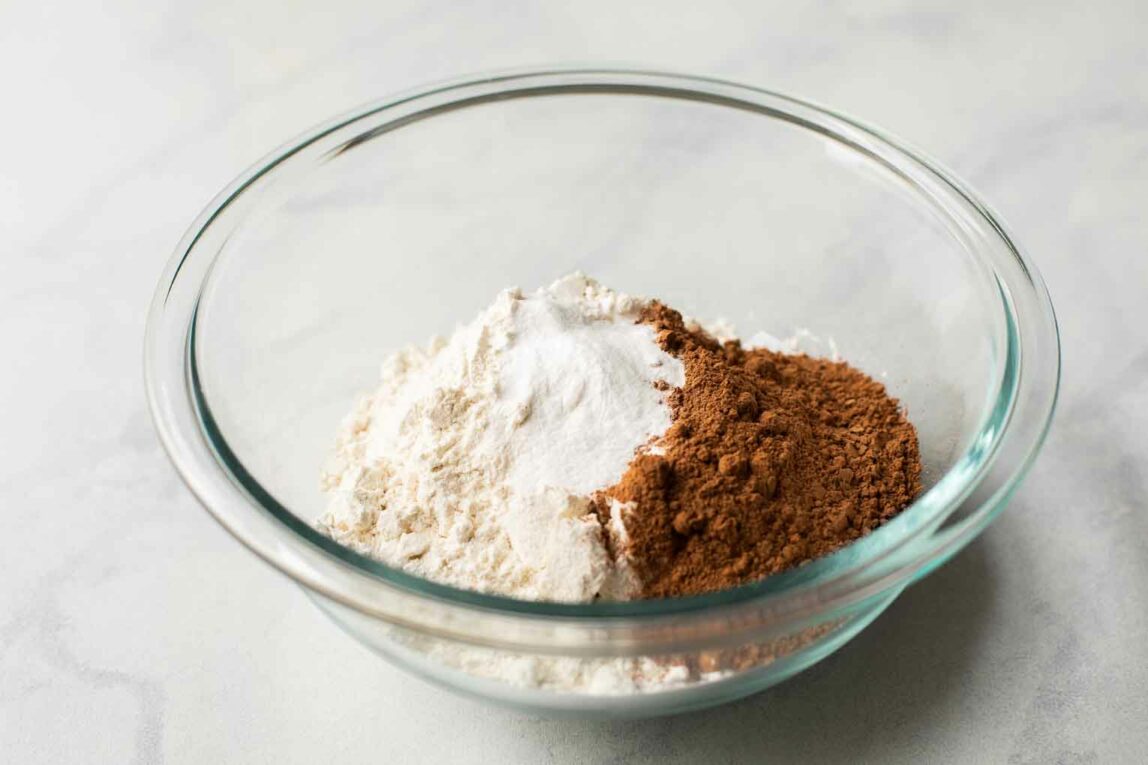 Glass bowl with dry ingredients for chocolate cookies.