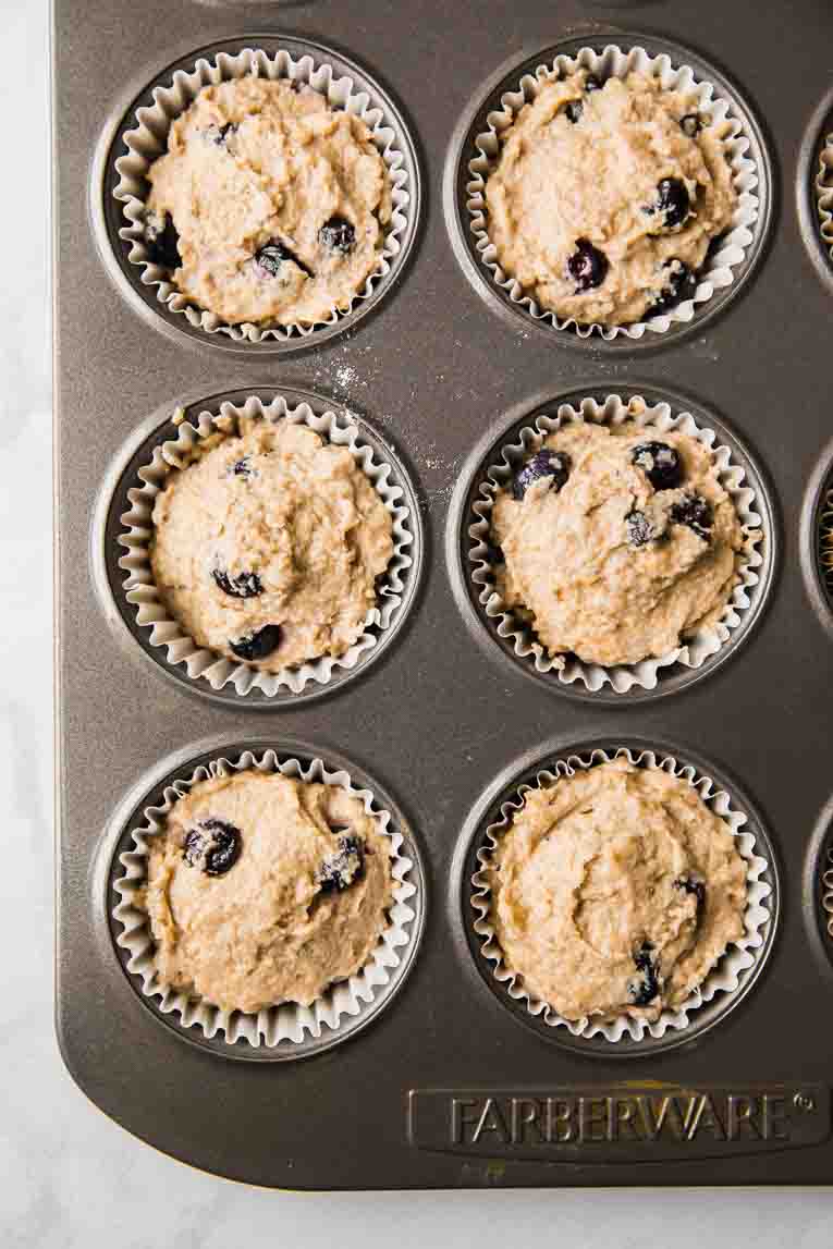Muffin batter poured into a muffin tin.
