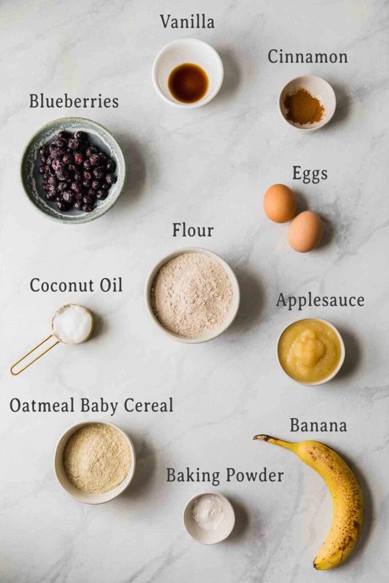 Ingredients for healthy toddler muffins on a marble background.