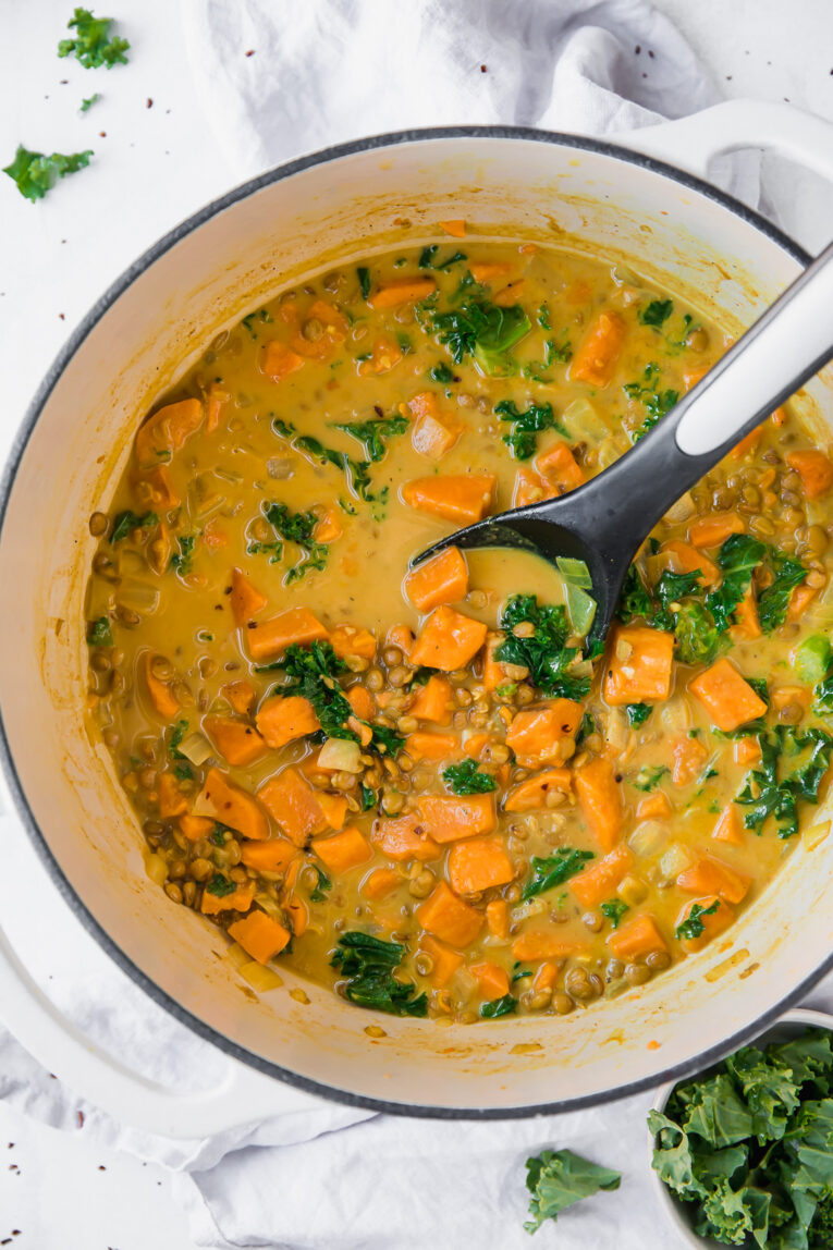 Vegetarian Lentil & Sweet Potato Curry Stew being made in a dutch oven.
