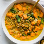 Top shot of Vegetarian Lentil & Sweet Potato Curry Stew in a white bowl.