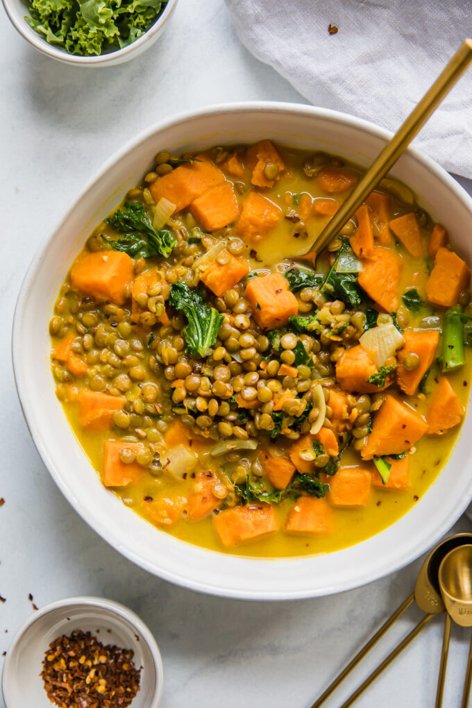 Top shot of Vegetarian Lentil & Sweet Potato Curry Stew in a white bowl.
