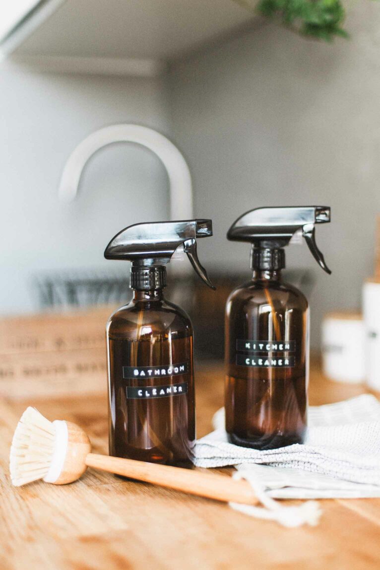 Two bottles of homemade cleaner on a counter.
