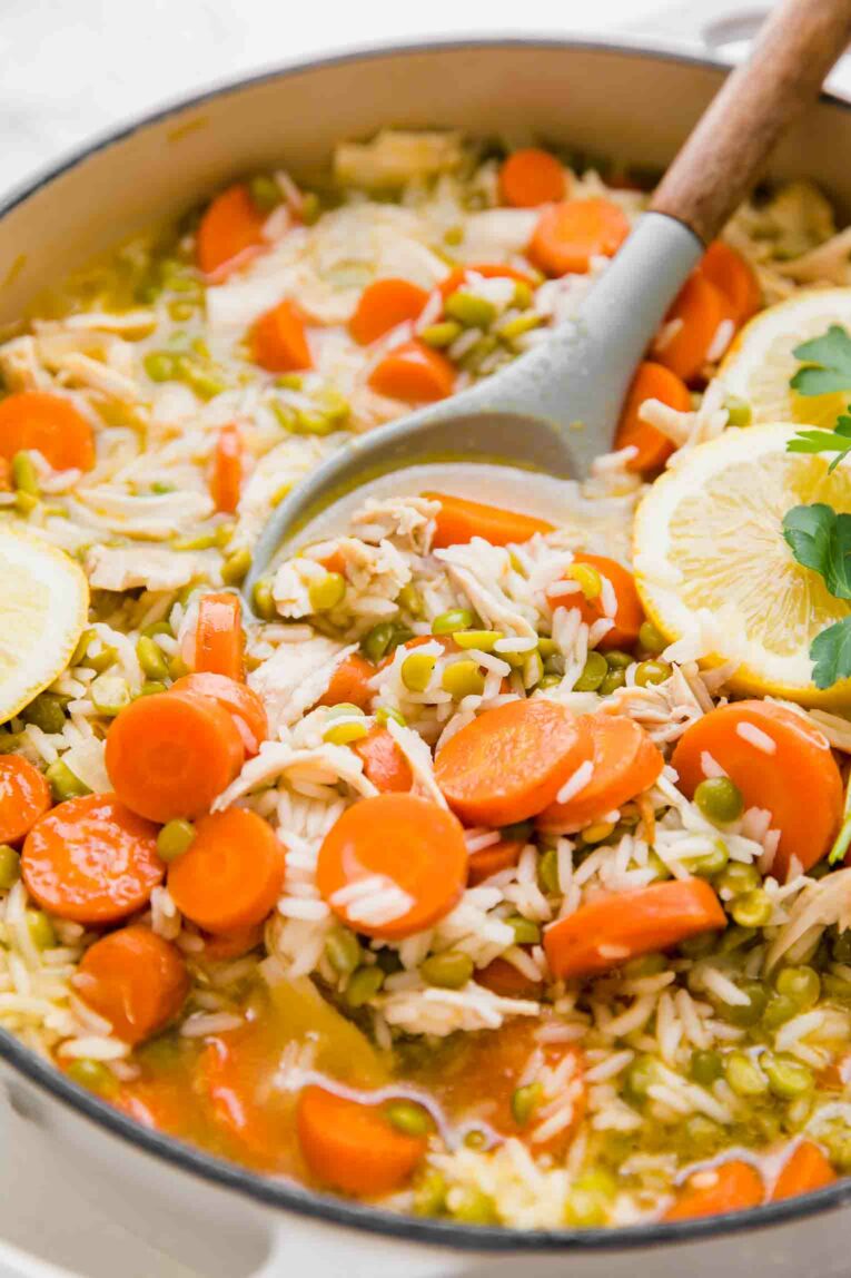 Angled shot of Chicken Lemon Rice Soup in a dutch oven.