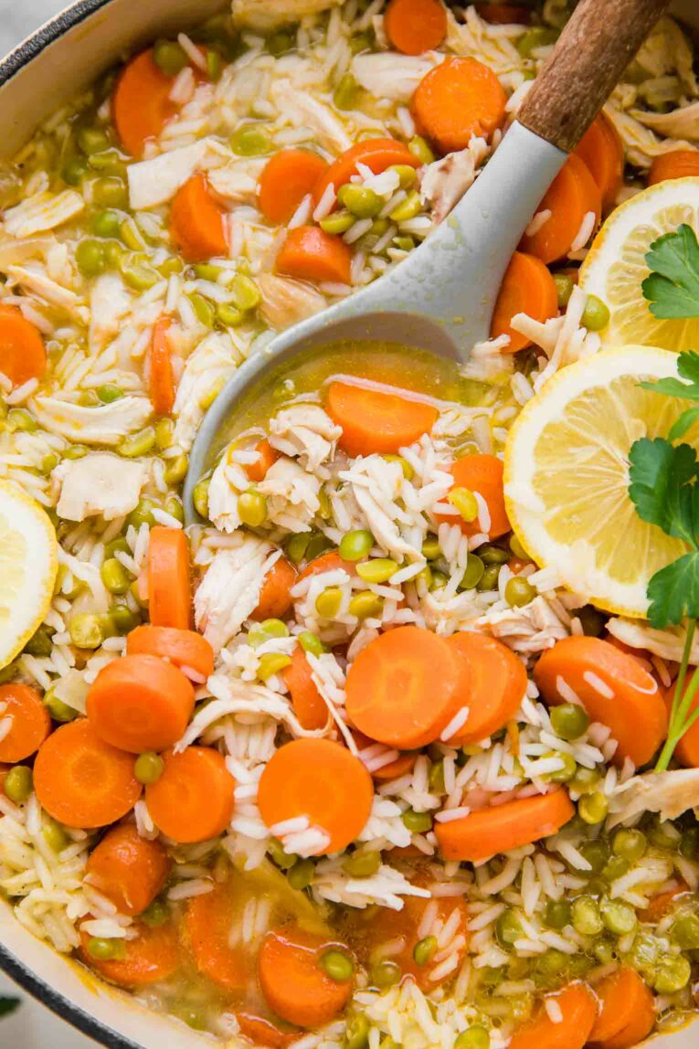 Close up of Chicken Lemon Rice Soup with a large spoon.