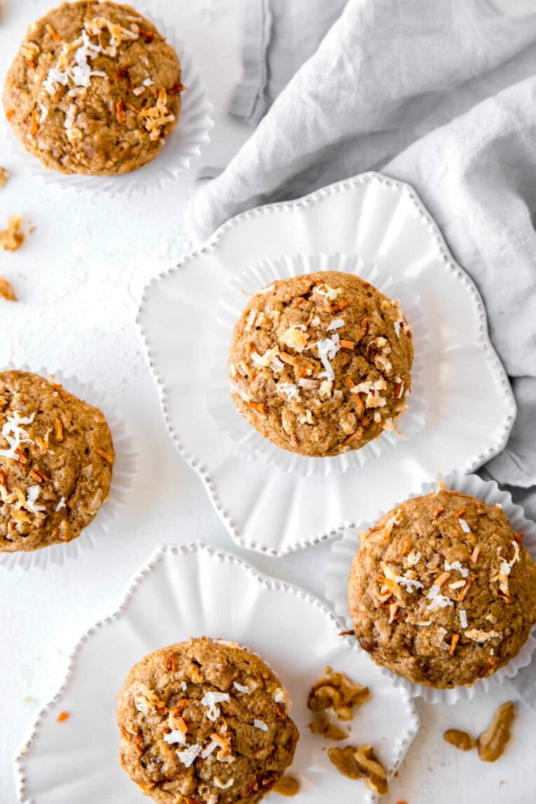 Close up of carrot cake muffins on white plates.