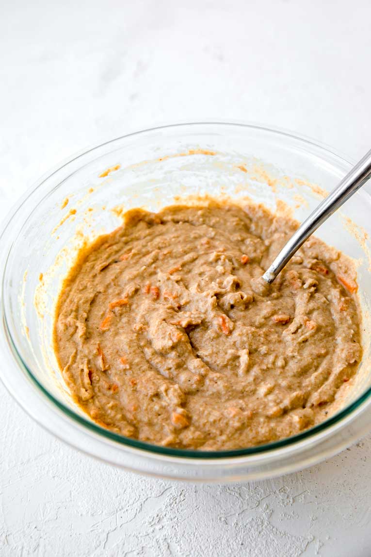 Carrot cake muffins batter in a glass bowl.