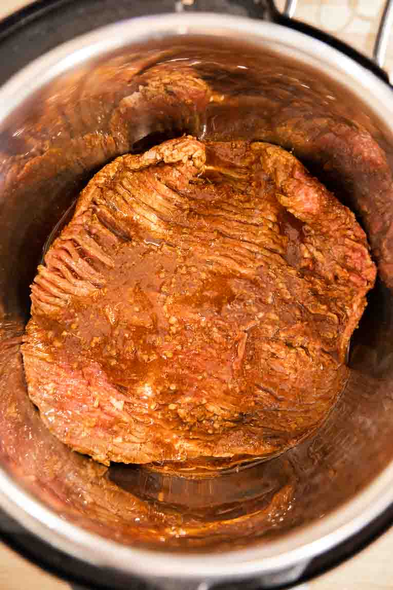 Flank steak being cooked in the Instant Pot.