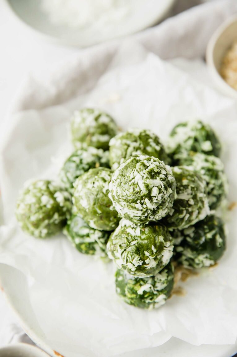 A pile of chia seed energy bites rolled in shredded coconut.