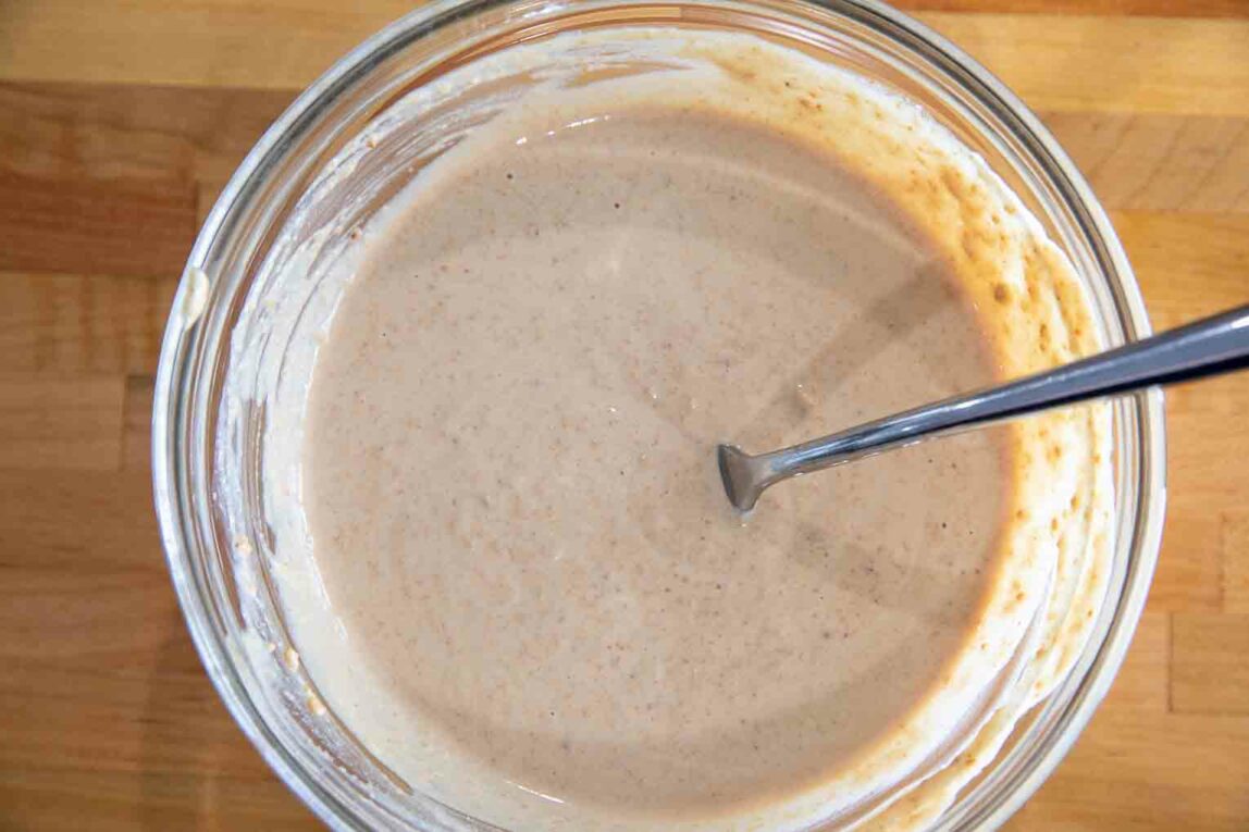 A bowl of cashew butter on a counter.