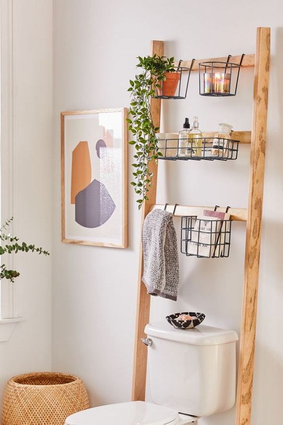 A ladder shelf over a toilet for storage. 