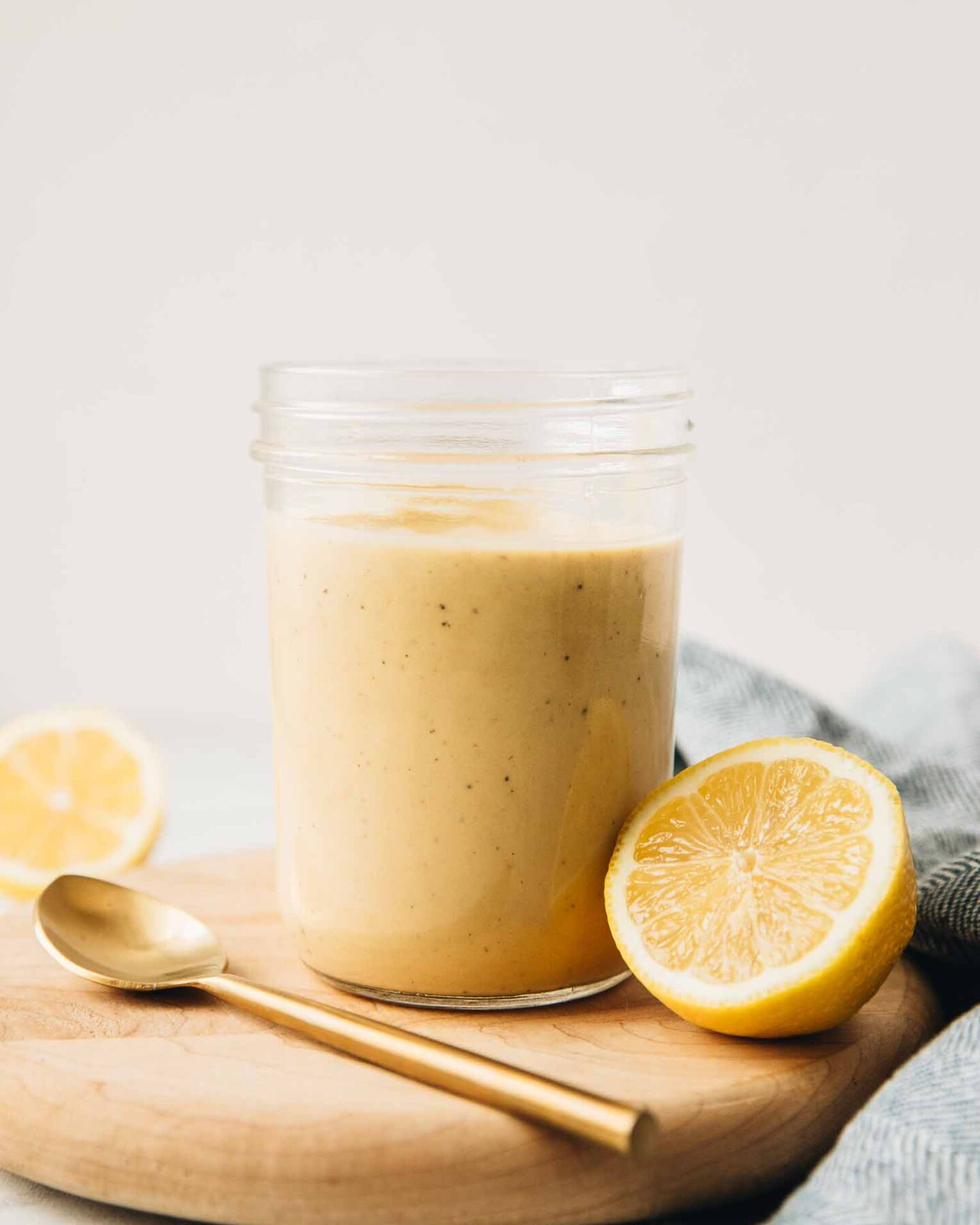 Close up of Creamy Lemon Tahini Dressing in a mason jar.