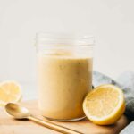 Close up of Creamy Lemon Tahini Dressing in a mason jar.