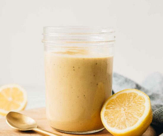 Close up of Creamy Lemon Tahini Dressing in a mason jar.
