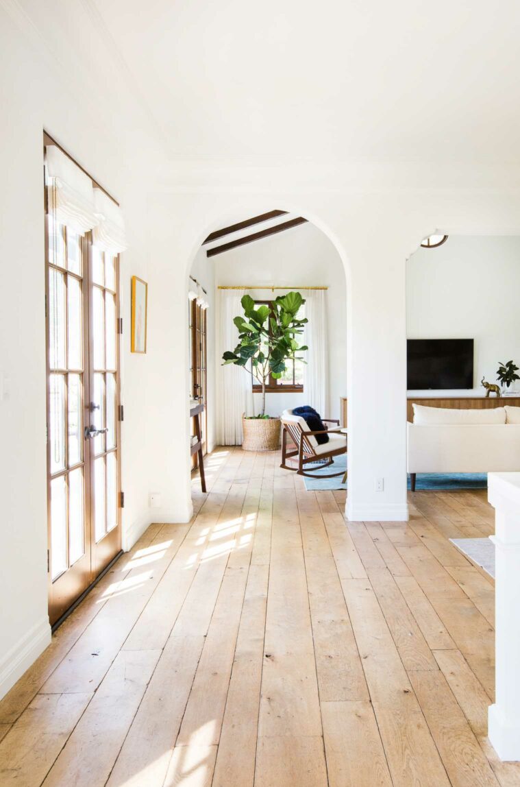 Hallway with wood floors and arch ways.