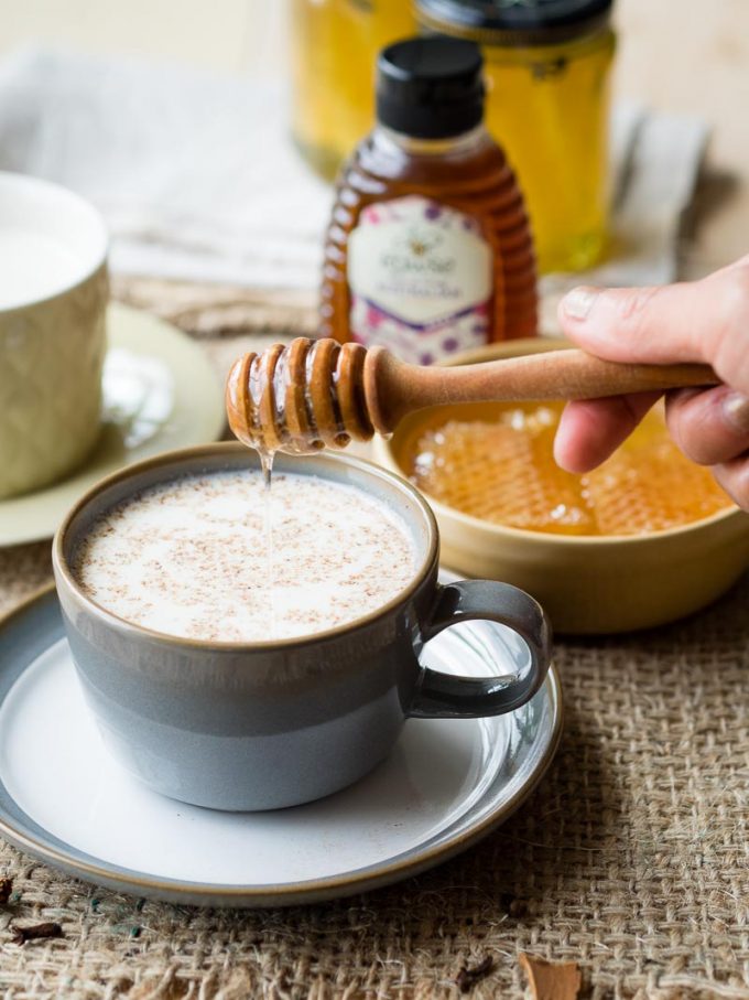 A tea cup of spiced milk with honey.