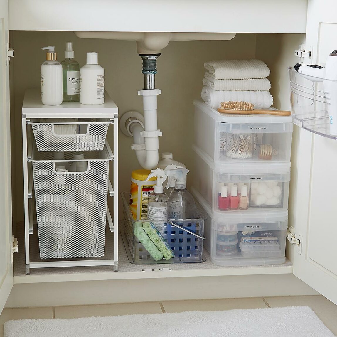 Under the sink of a bathroom with storage.