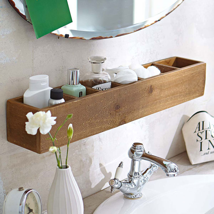 A wooden shelf on a small bathroom sink. 