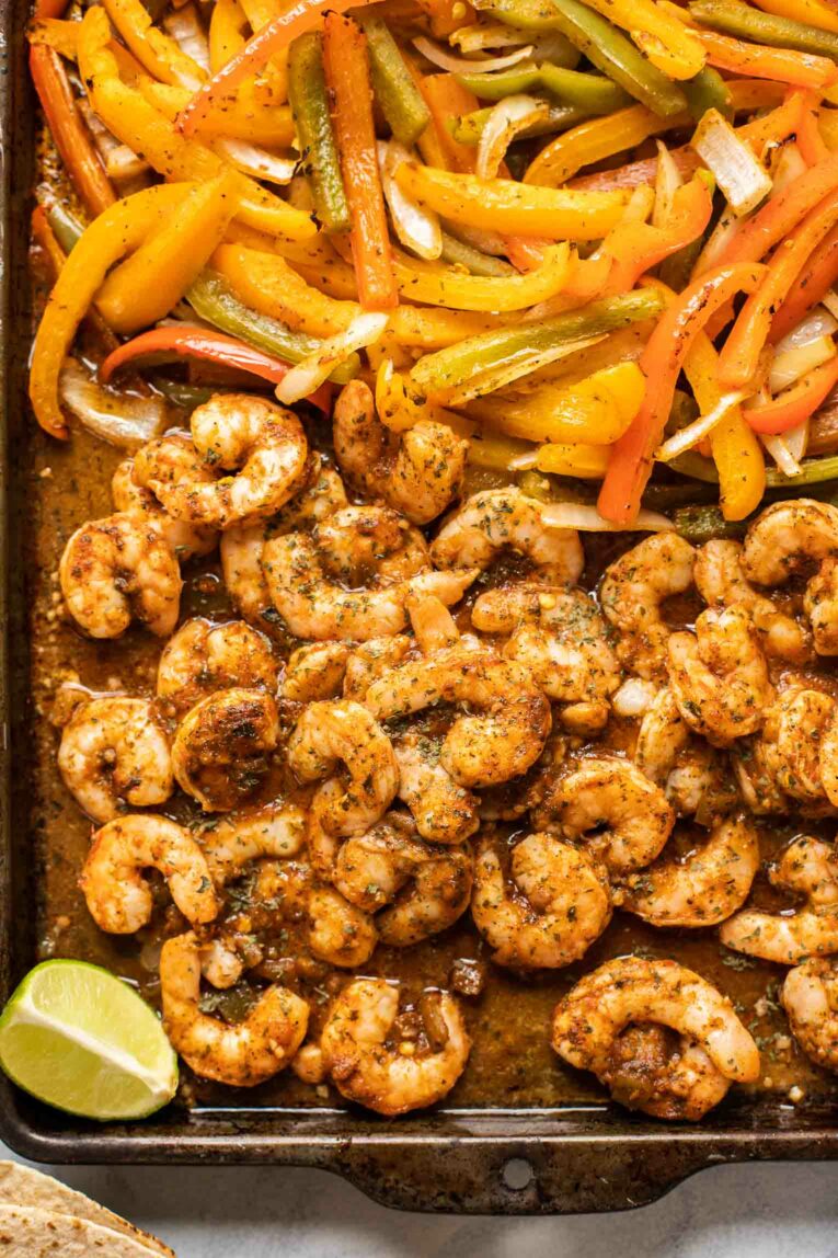 Close up of shrimp fajitas on a baking pan.