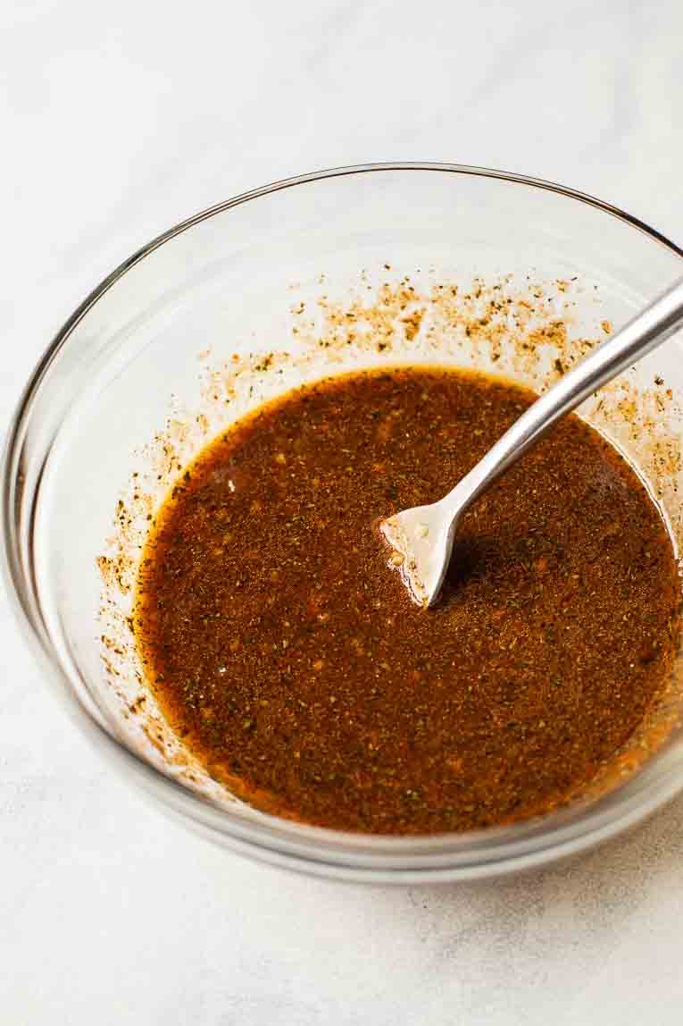 Close up of shrimp marinade for fajitas in a bowl.