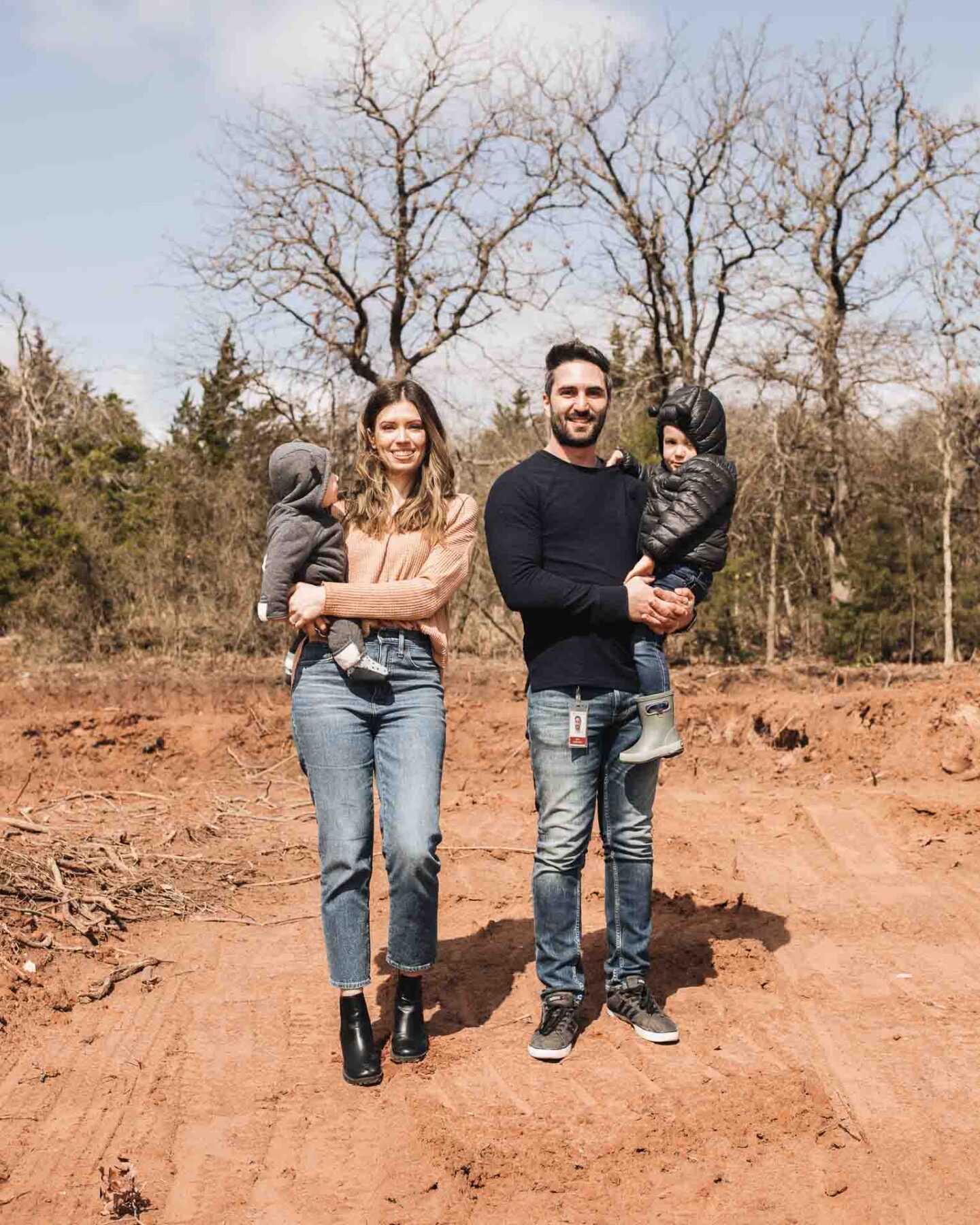 Family on empty lot for building a home.