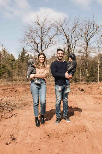 Family on empty lot for building a home.