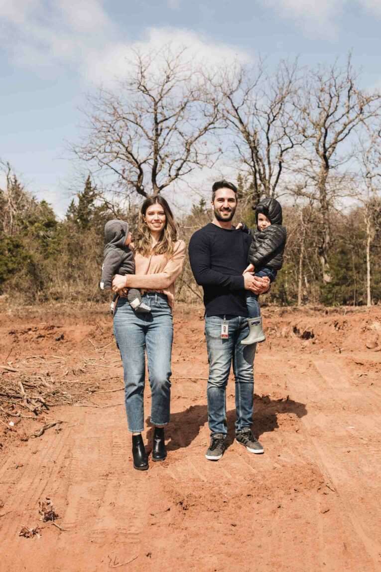 Family on empty lot for building a home.