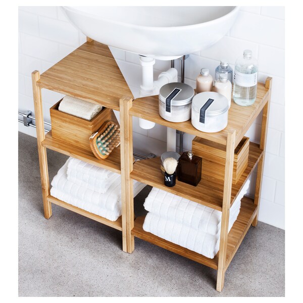 A pedestal sink with storage unit underneath.