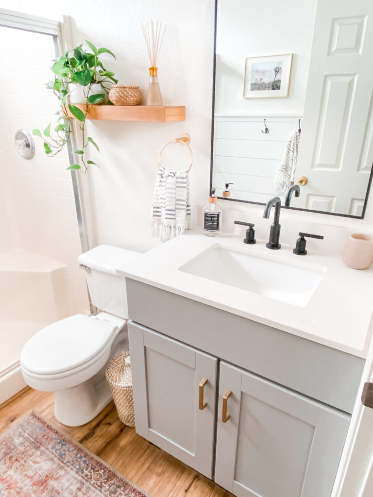 A small bathroom with a mirror and sink. 