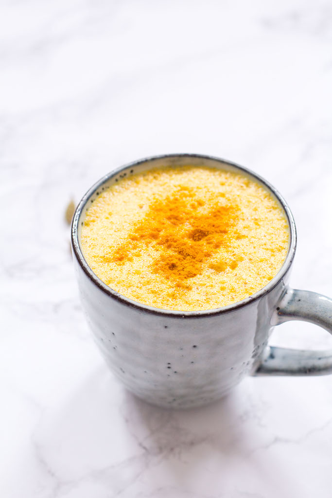 A photo of a turmeric latte on a table. 