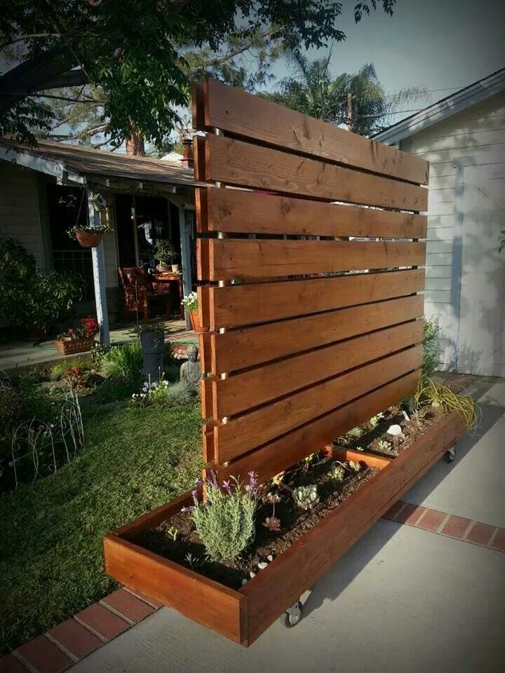A large plank wall made on wheels.