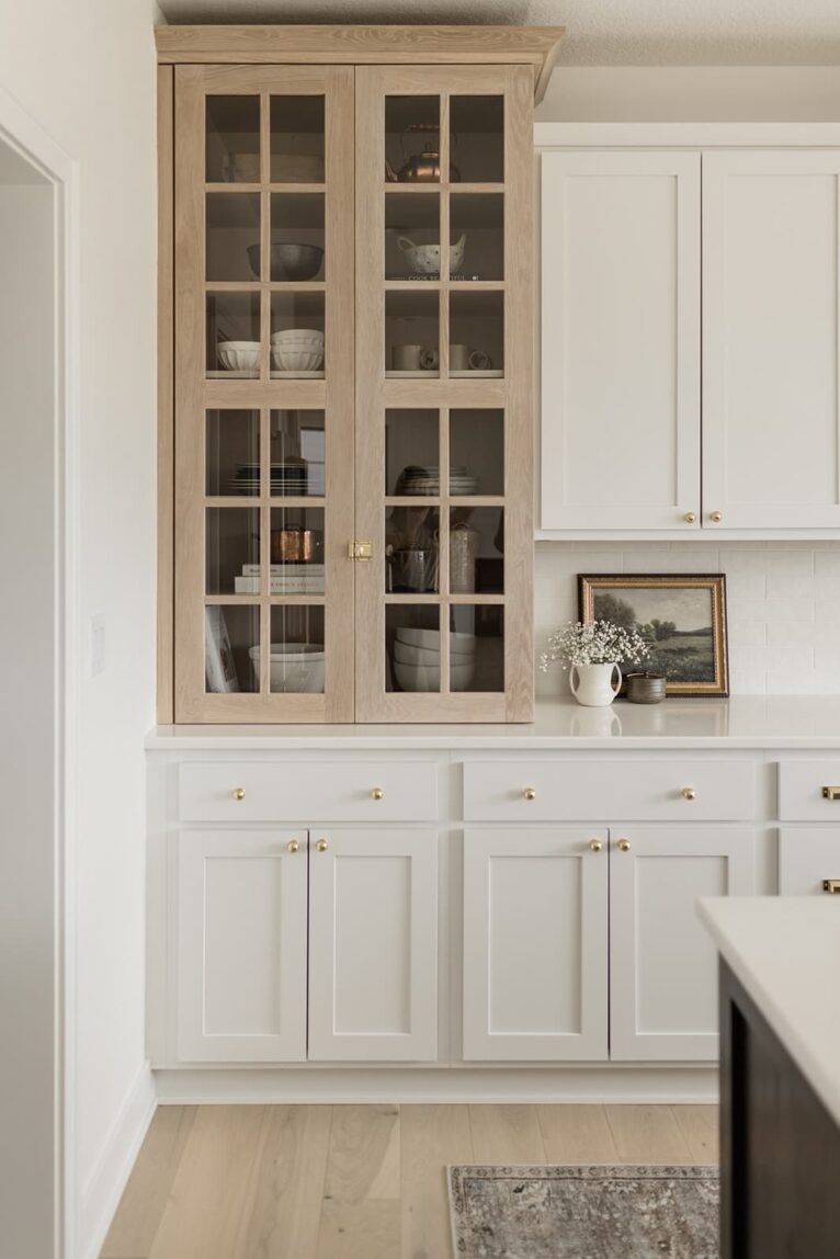 White cabinets with glass upper cabinets.