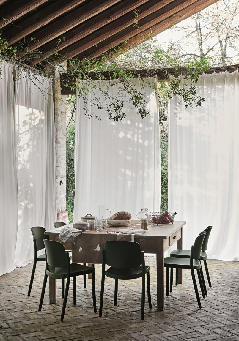 A patio with sheer curtains.