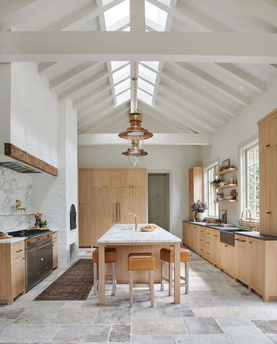 Warm wood toned cabinets in a white and grey kitchen.