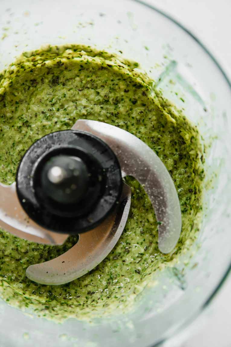 The ingredients of spinach basil pesto in a blender.